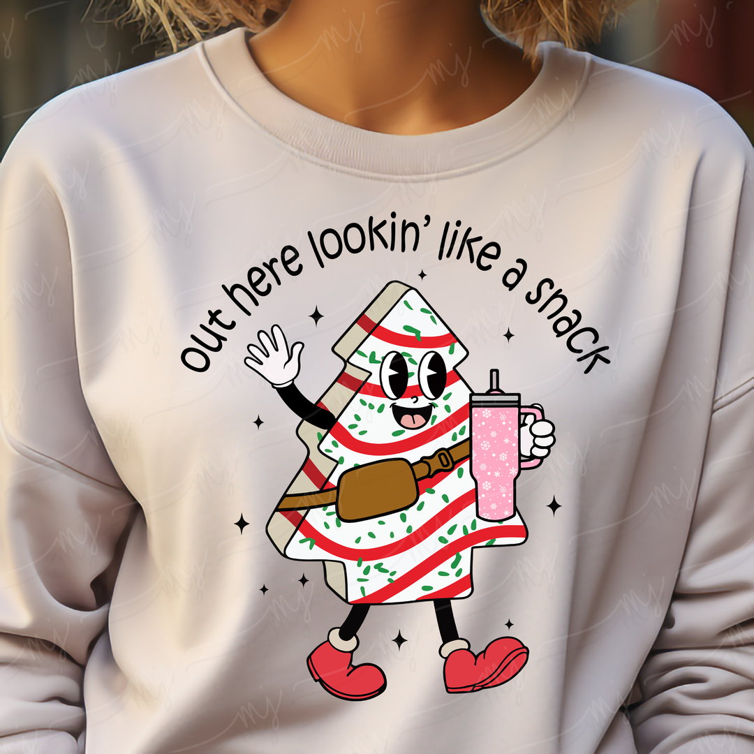 a woman wearing a white sweatshirt with a christmas tree on it