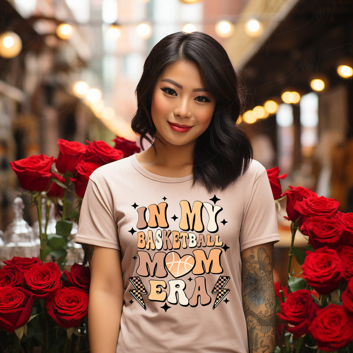 a woman standing in front of a bunch of red roses