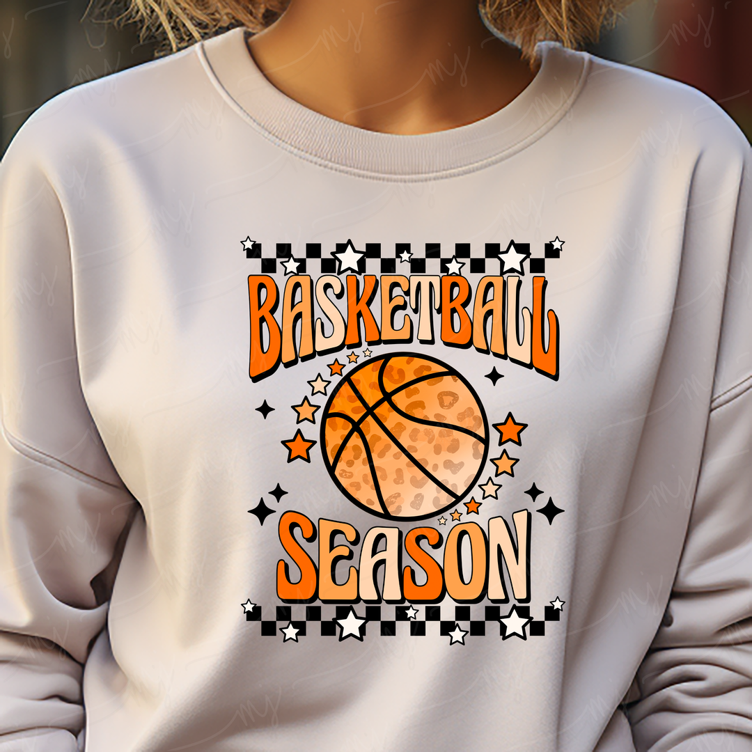 a woman wearing a sweatshirt with a basketball on it