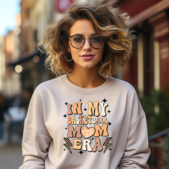 a woman wearing a sweatshirt that says in my baseball mom era