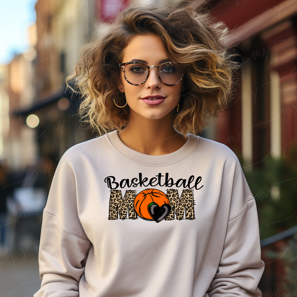 a woman wearing a basketball mom sweatshirt and glasses