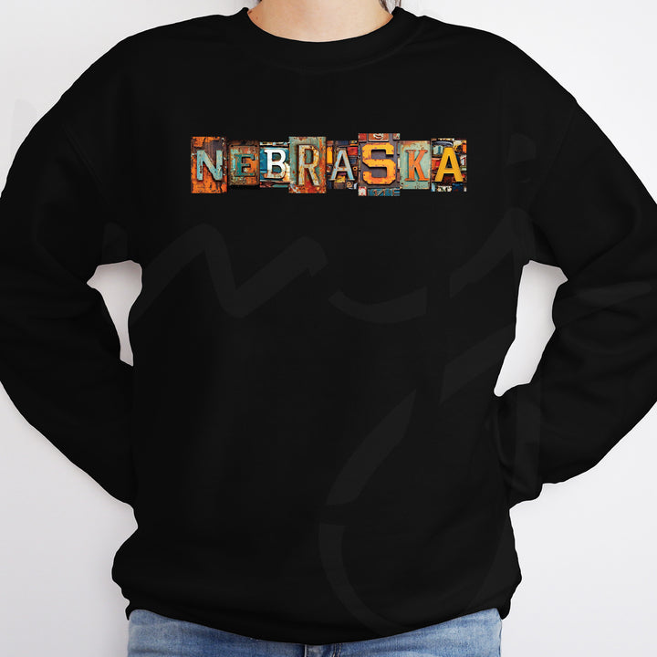 a man wearing a black sweatshirt with the word nebrasta printed on it