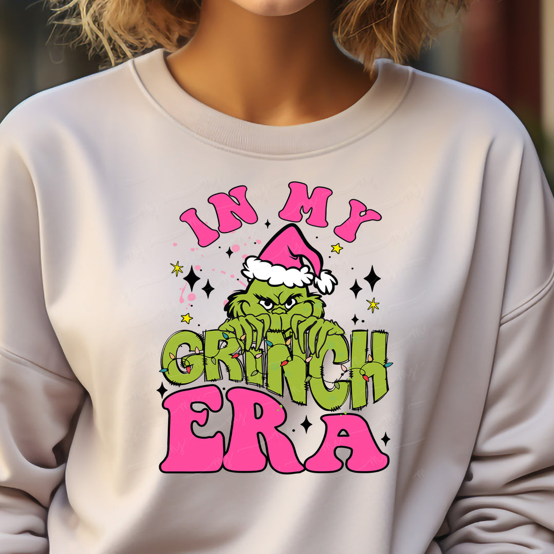 a woman wearing a sweatshirt that says in my grinch era