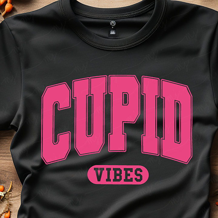 a cupid t - shirt sitting on top of a wooden table