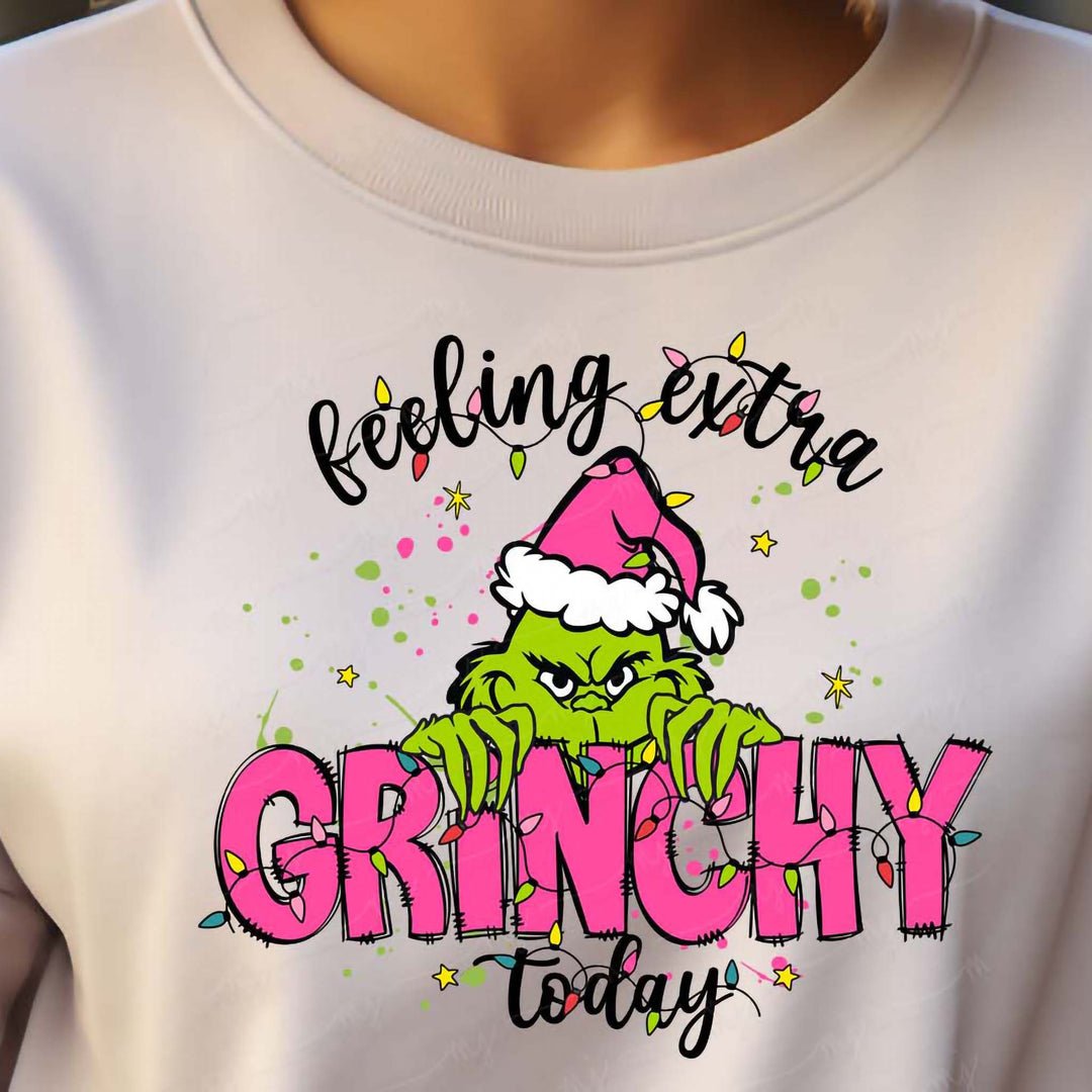 a woman wearing a white shirt with a grinch on it