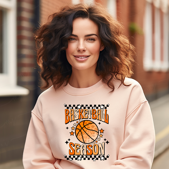 a woman wearing a sweatshirt with a basketball on it
