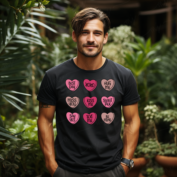a man wearing a black shirt with pink hearts on it