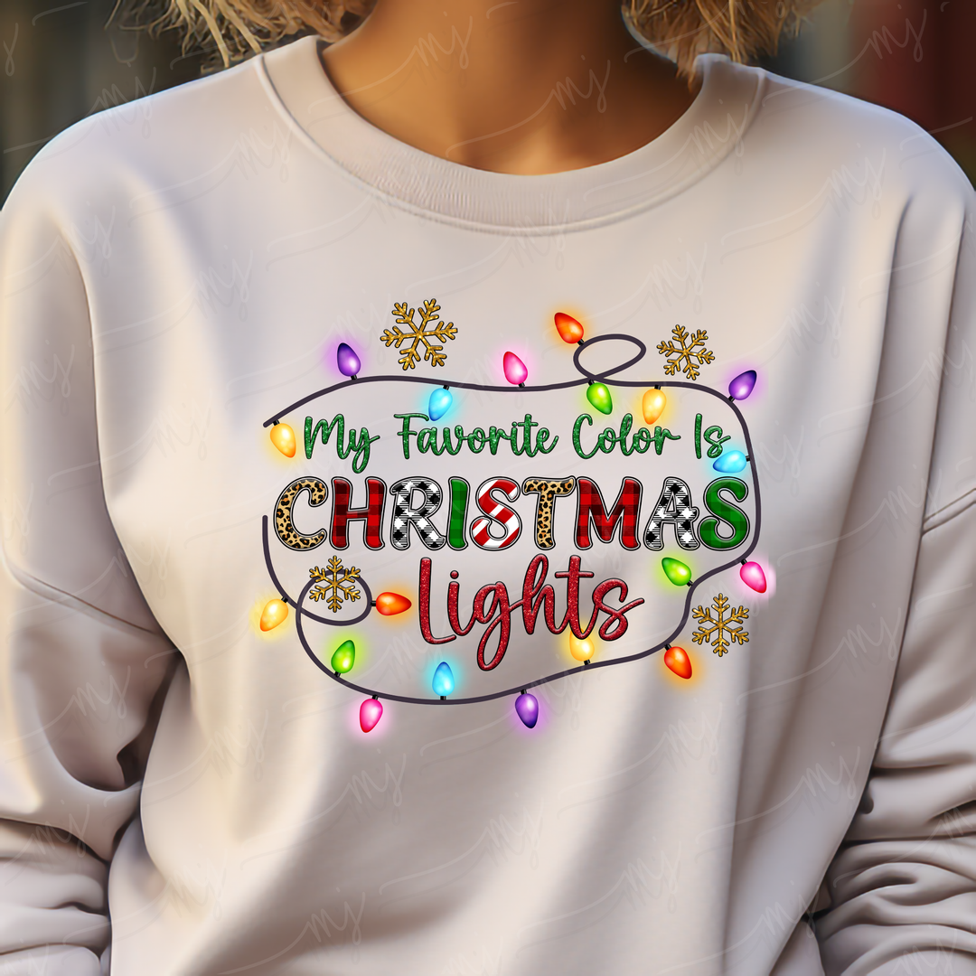 a woman wearing a white christmas sweatshirt with lights on it